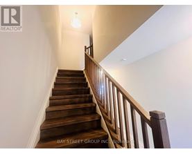 A staircase with wooden steps and a railing.