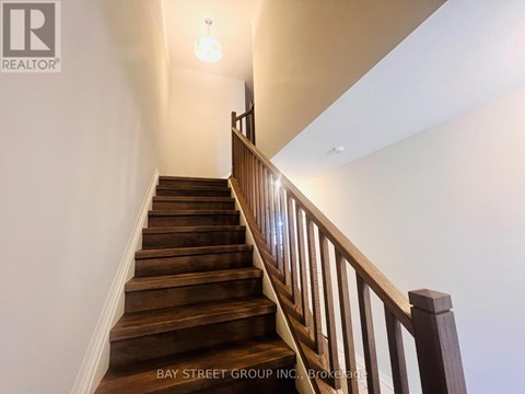 A staircase with wooden steps and a railing.
