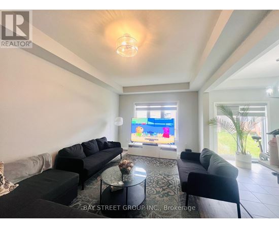 A living room with a large couch and a television.