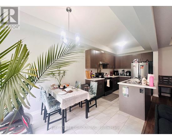 A well-lit kitchen with a dining table set for two.