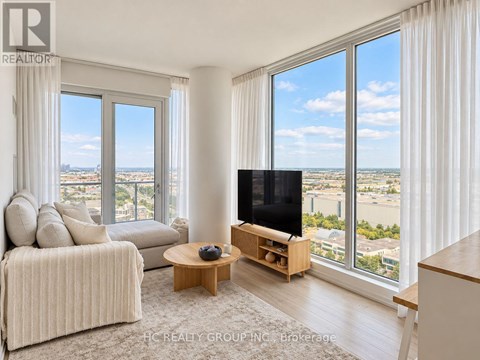 A living room with a couch, a coffee table, and a television.