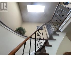 A staircase with a metal railing and wooden steps.
