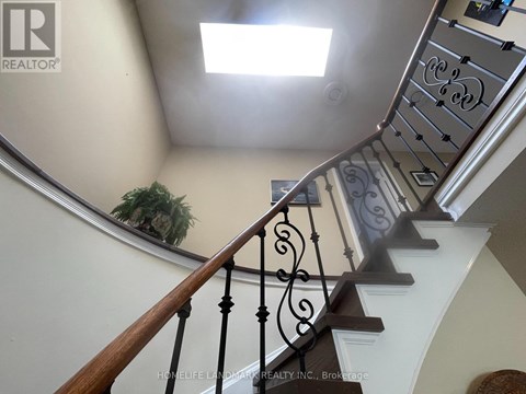 A staircase with a metal railing and wooden steps.