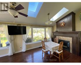 A living room with a fireplace and a TV mounted on the wall.