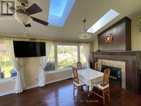 A living room with a fireplace and a TV mounted on the wall.