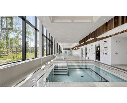 A large indoor swimming pool with a glass wall on one side.