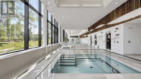 A large indoor swimming pool with a glass wall on one side.
