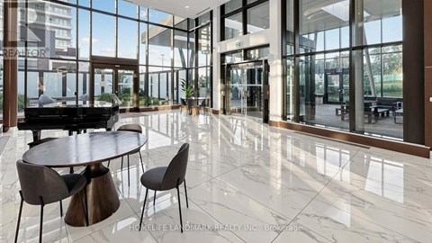 A modern dining area with a piano and a view of the outside.