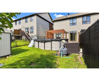 A backyard with a pool and a fence.