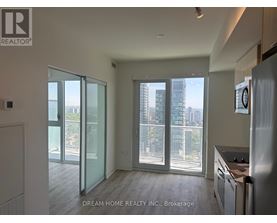 A modern kitchen with a view of the city through large windows.