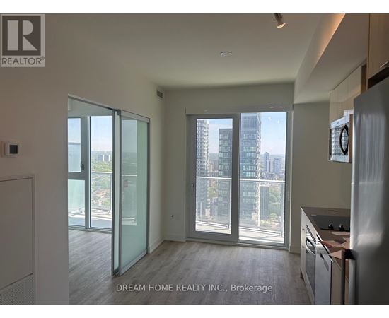A modern kitchen with a view of the city through large windows.