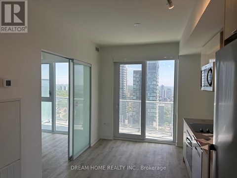 A modern kitchen with a view of the city through large windows.
