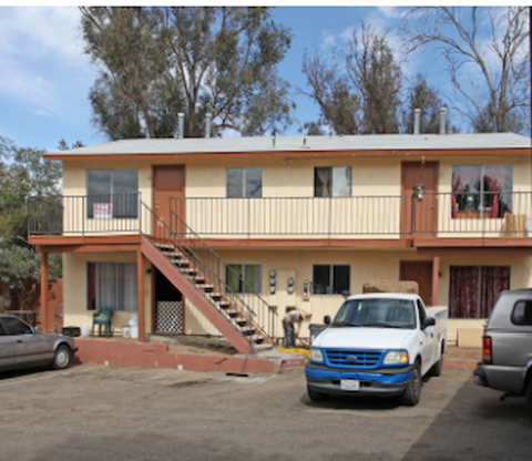 A two story house with a white truck in front.