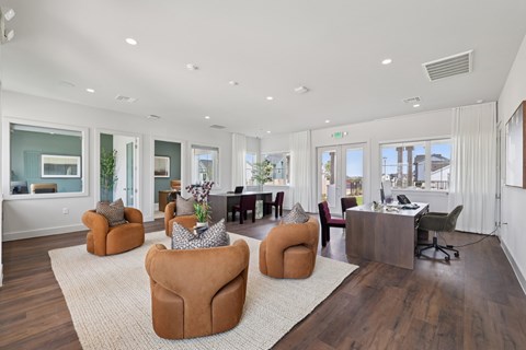 A spacious office with brown chairs and a white rug.