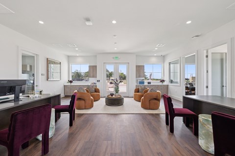 A modern office space with a long table and chairs.