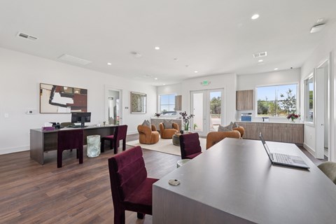 A modern office with a long table and chairs.