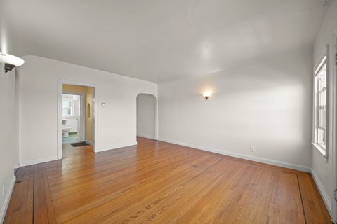 A room with wooden floors and white walls.