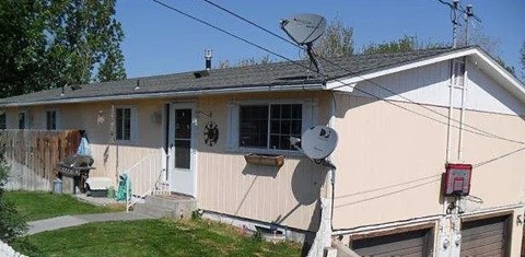 A house with a satellite dish on the roof.