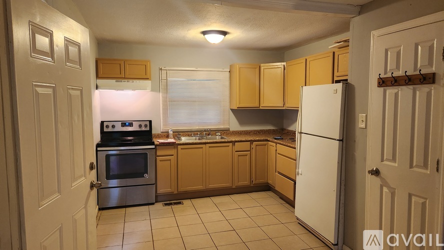 A kitchen with wooden cabinets and a white refrigerator.