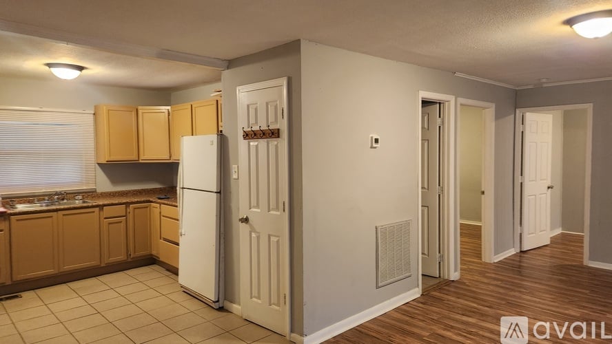 A kitchen with wooden cabinets and a white refrigerator.