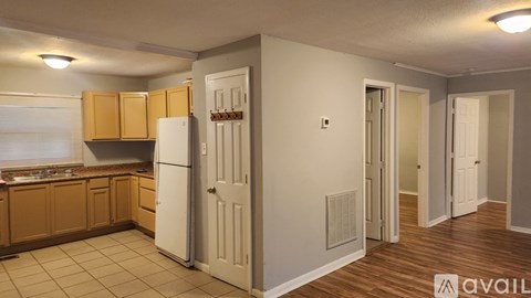 A kitchen with wooden cabinets and a white refrigerator.