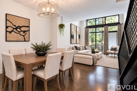 A modern dining room with a wooden table and chairs.