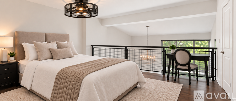 A bedroom with a large bed and a balcony.