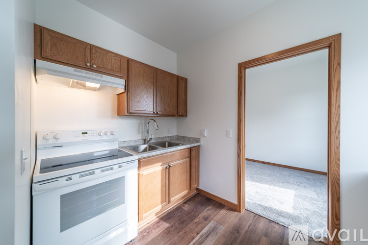 A kitchen with wooden cabinets and a white oven.