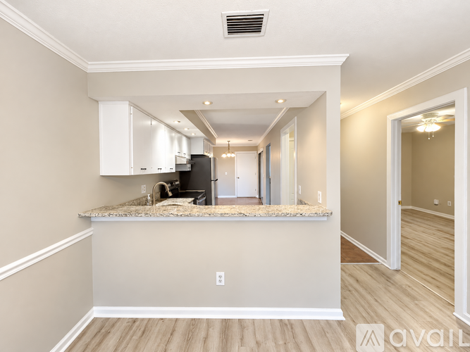 A kitchen with a countertop and cabinets is available for rent.