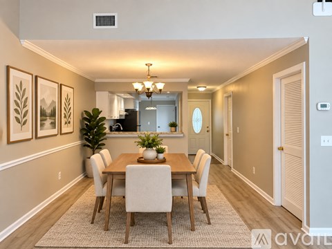 A dining room with a wooden table and chairs.