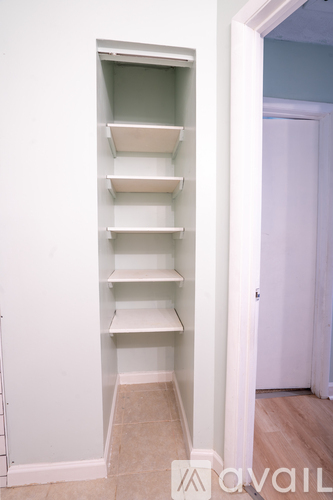 A white shelving unit with seven shelves is open.