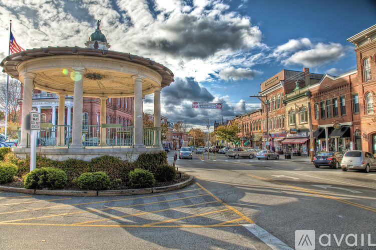 A city street with a gazebo in the middle of the road.