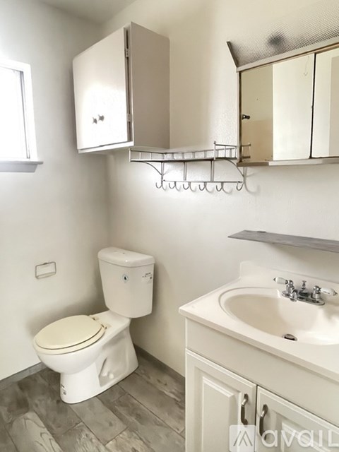 A white toilet sits next to a sink in a bathroom.