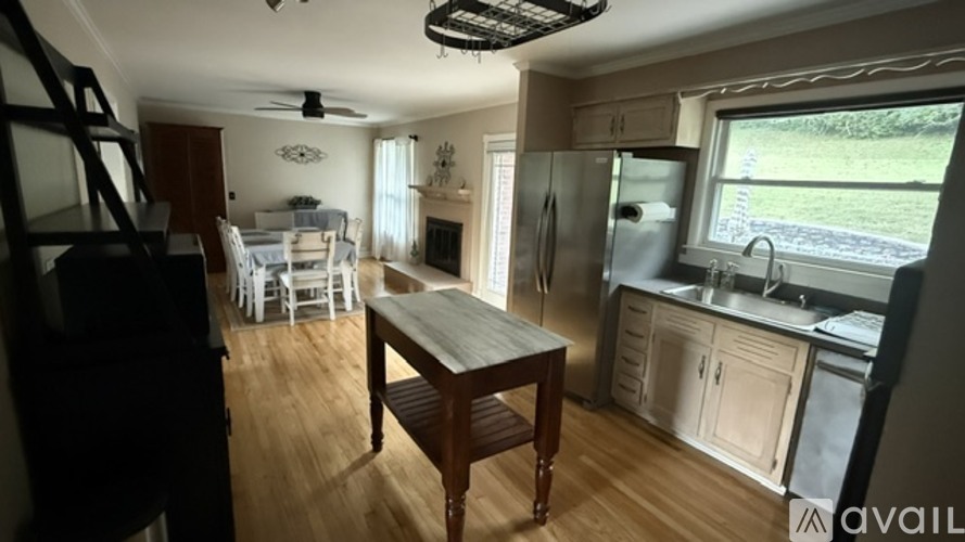 A kitchen with a table and chairs in the middle of the room.