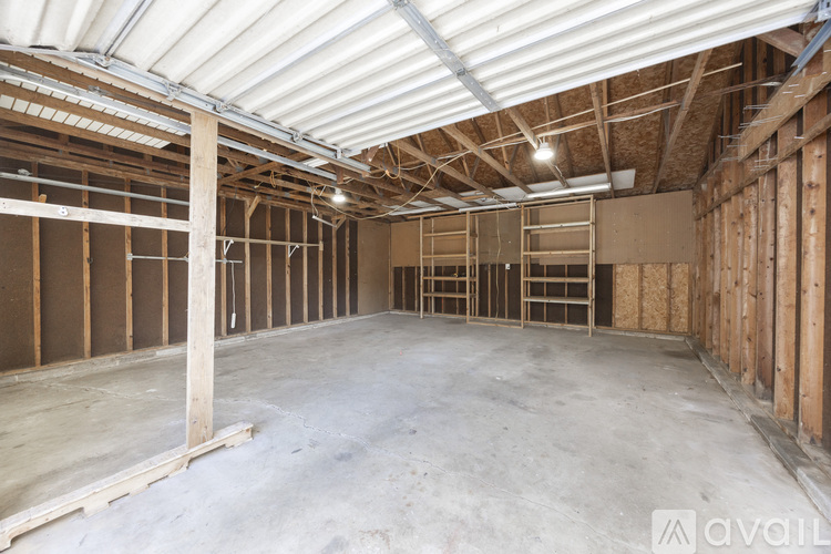 A large, empty room with wooden framing and a white ceiling.
