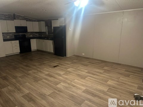 A kitchen with black appliances and white cabinets.