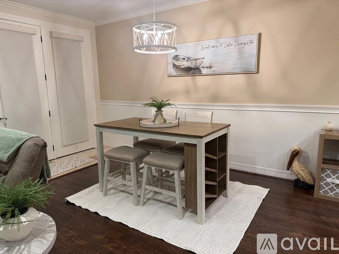 A dining area with a wooden table and chairs.