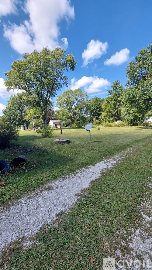 A sign is on a pole in a grassy area.
