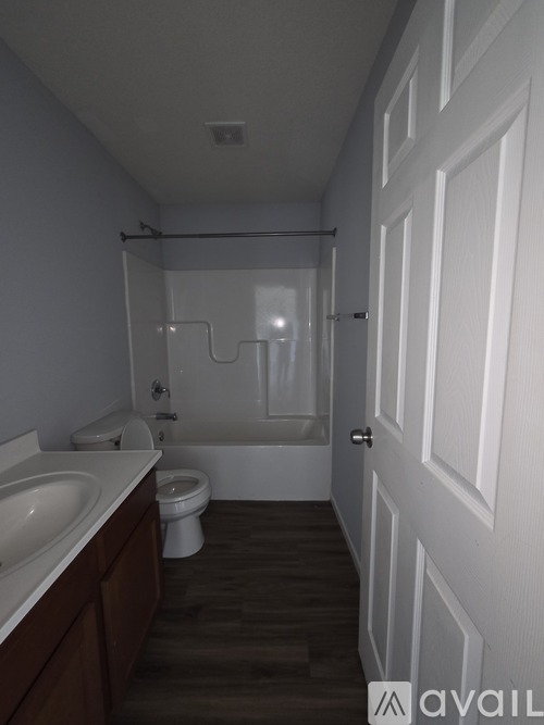 A bathroom with a toilet, sink, and bathtub.