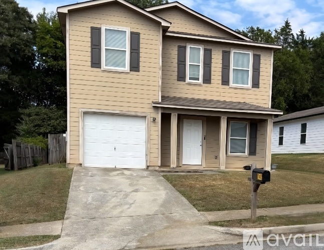 A two-story house with a garage is for sale.