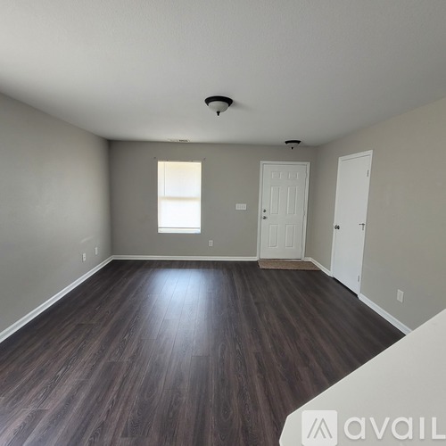 A room with wooden floors and white walls.
