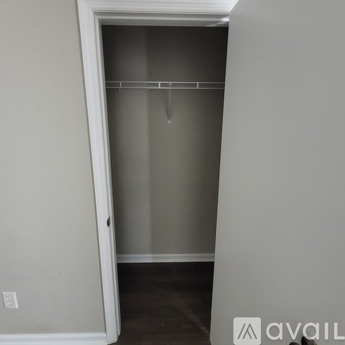 A white door with a hanger on the inside.