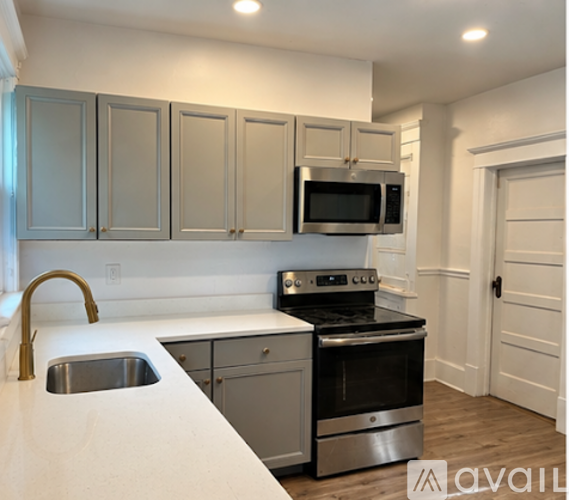 A kitchen with a stove top oven and microwave above a counter.