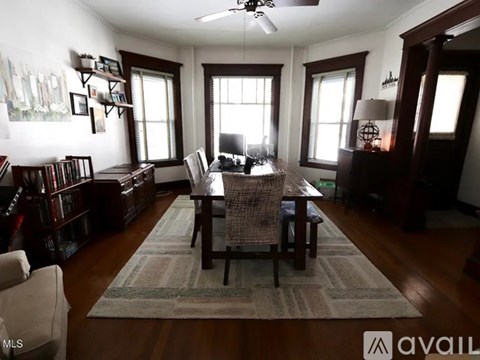 A well-lit dining room with a table set for four.