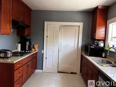 A kitchen with brown cabinets and a white refrigerator.
