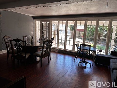 A dining room with a table and chairs.