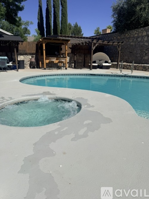 A pool with a hot tub in the middle of it.