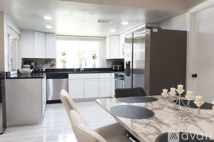 A modern kitchen with a dining table set for four.