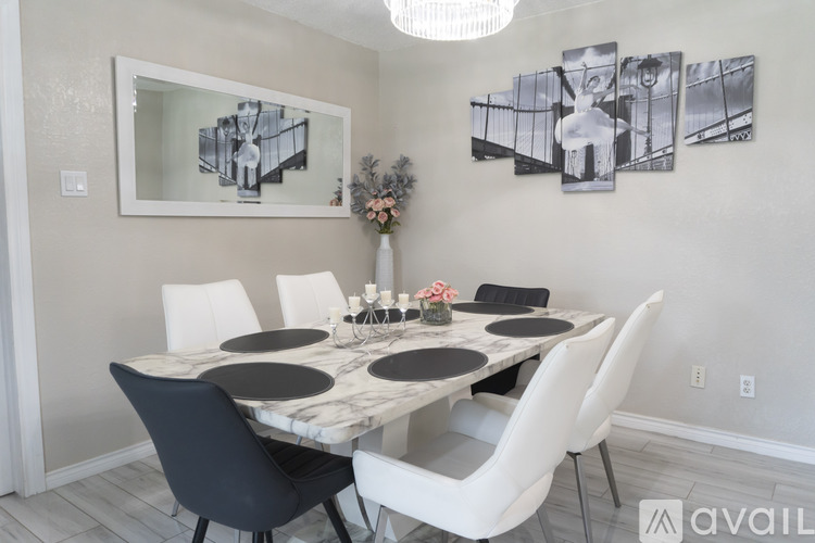 A dining room with a marble table and chairs.