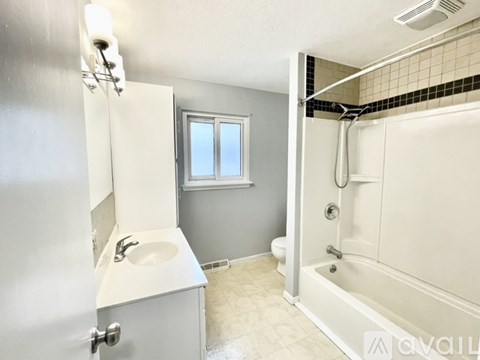 A bathroom with a sink, toilet, and bathtub.